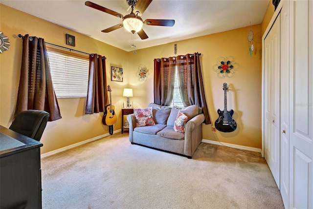 interior space with light carpet and ceiling fan