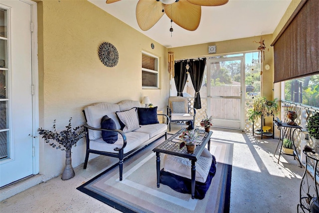 sunroom featuring ceiling fan