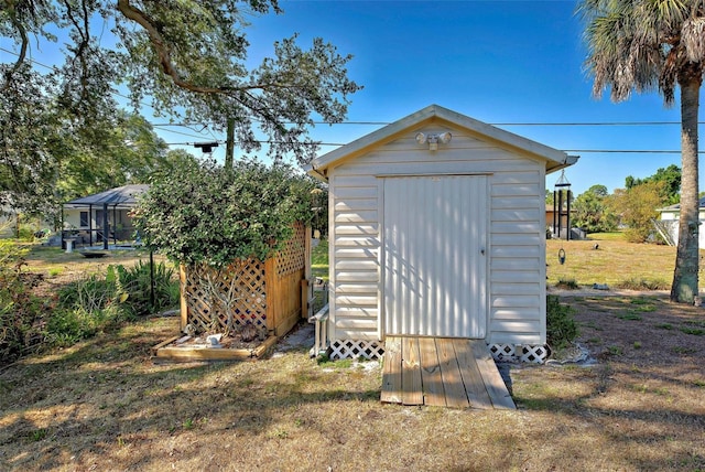 view of outbuilding featuring a yard