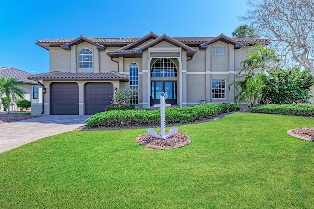 view of front of home with french doors, a garage, and a front lawn