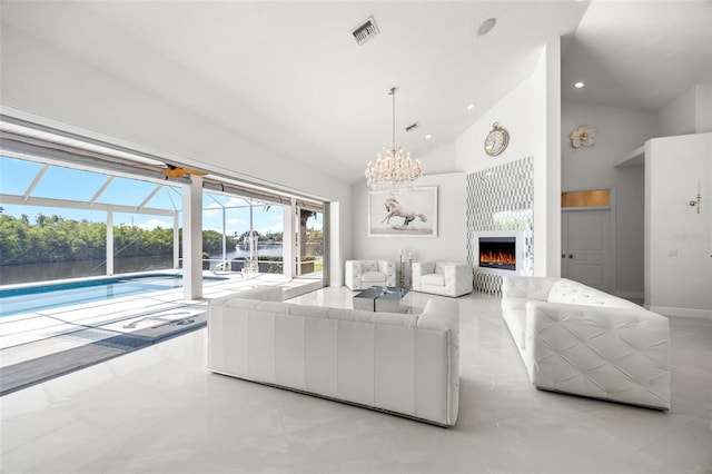 tiled living room featuring a notable chandelier and high vaulted ceiling