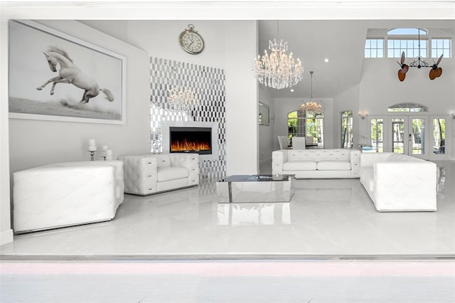 living room featuring a high ceiling, a notable chandelier, and french doors