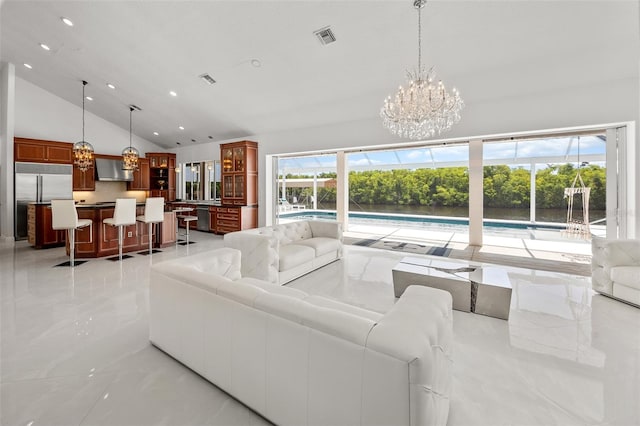 tiled living room featuring high vaulted ceiling and a chandelier