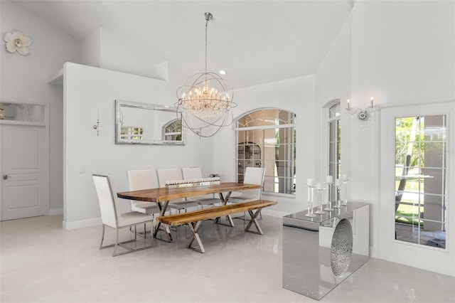 tiled dining room with high vaulted ceiling and an inviting chandelier