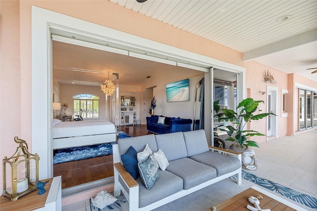 living room featuring ceiling fan with notable chandelier and hardwood / wood-style flooring