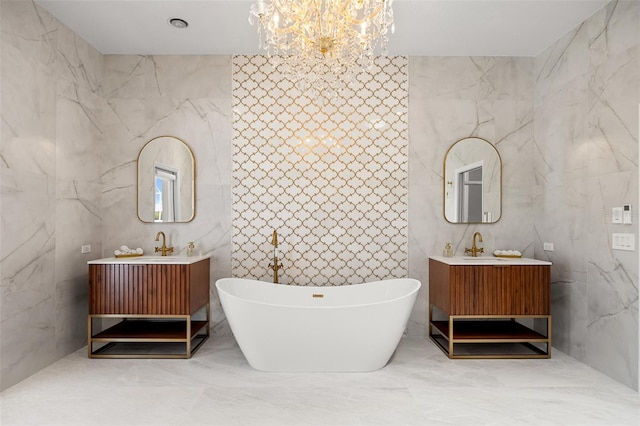 bathroom featuring tile flooring, a tub, a chandelier, tile walls, and vanity