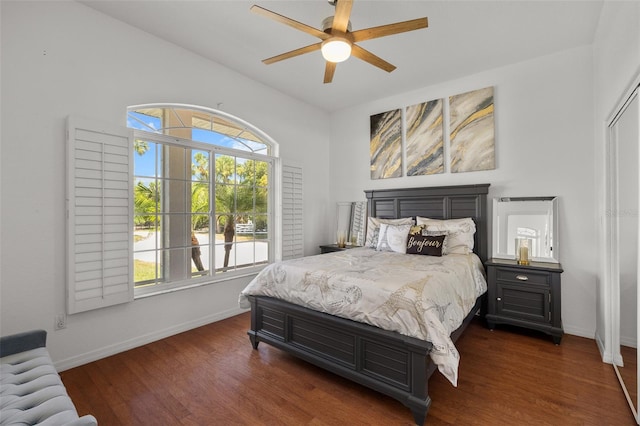 bedroom with ceiling fan, dark hardwood / wood-style floors, and multiple windows