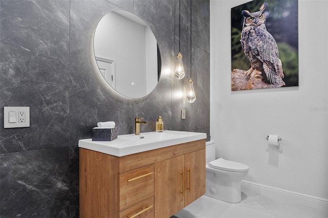 bathroom with tile floors, tile walls, toilet, and vanity