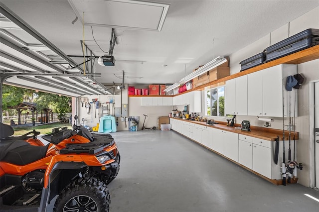 garage with a workshop area and a garage door opener