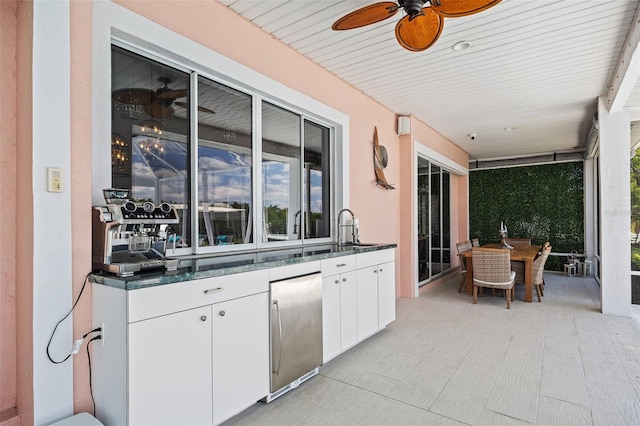 view of terrace featuring ceiling fan and sink