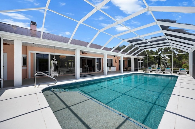 view of swimming pool with a lanai and a patio area