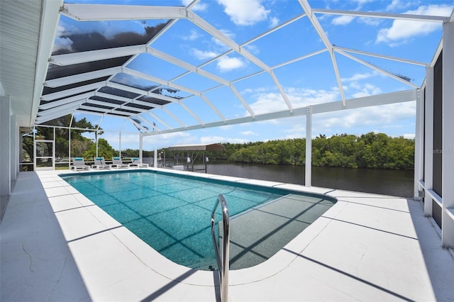 view of swimming pool featuring a patio, glass enclosure, and a water view