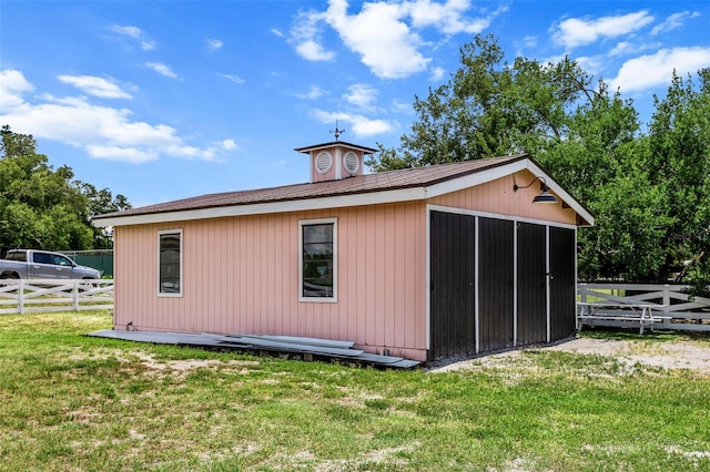 view of home's exterior with a yard and an outdoor structure