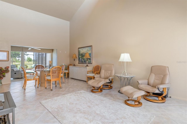 living room with light tile patterned floors and high vaulted ceiling