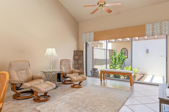 living area featuring light tile patterned floors, ceiling fan, and lofted ceiling