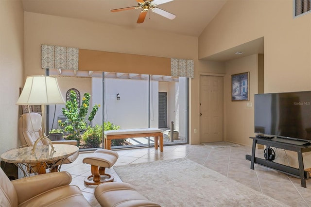 tiled living room featuring ceiling fan and high vaulted ceiling