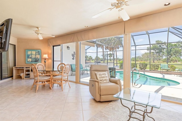 sunroom / solarium featuring ceiling fan and a pool