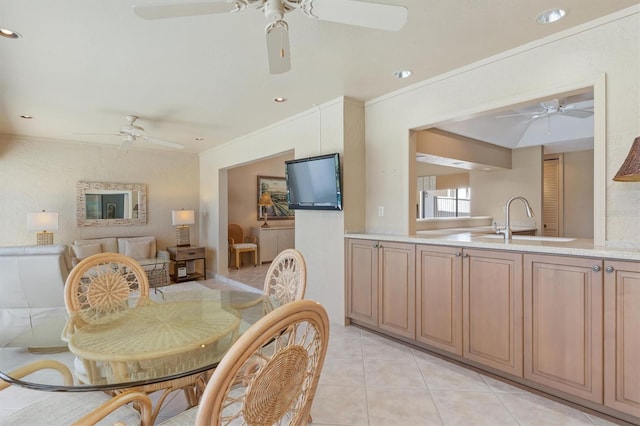 tiled dining room featuring ornamental molding and sink