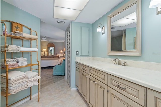 bathroom with ceiling fan, tile patterned flooring, and vanity