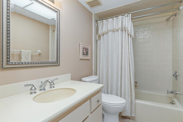 full bathroom featuring shower / bath combination with curtain, vanity, and toilet