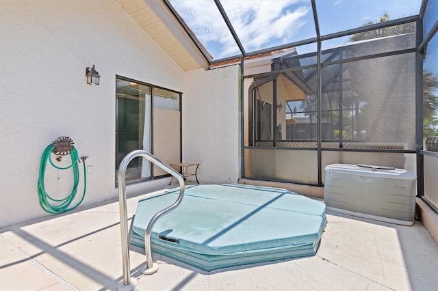 view of patio with glass enclosure