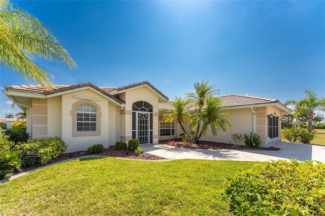 mediterranean / spanish house featuring a front yard