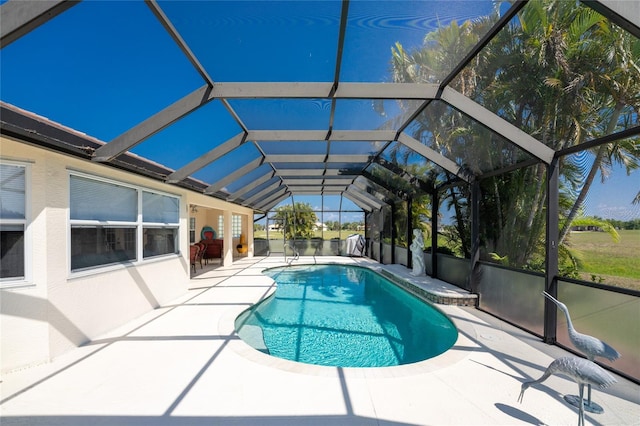 view of swimming pool with a lanai and a patio