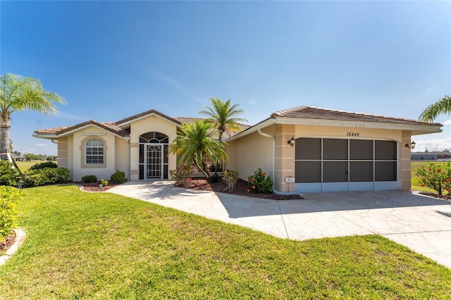 view of front of property with a garage and a front lawn