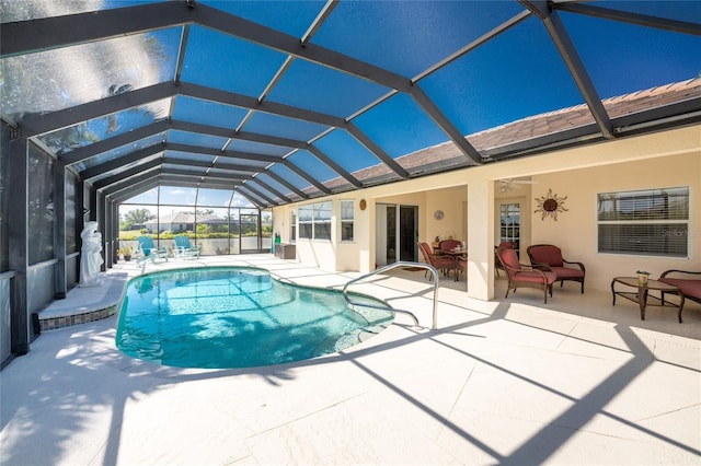 view of swimming pool featuring a patio area, ceiling fan, and a lanai