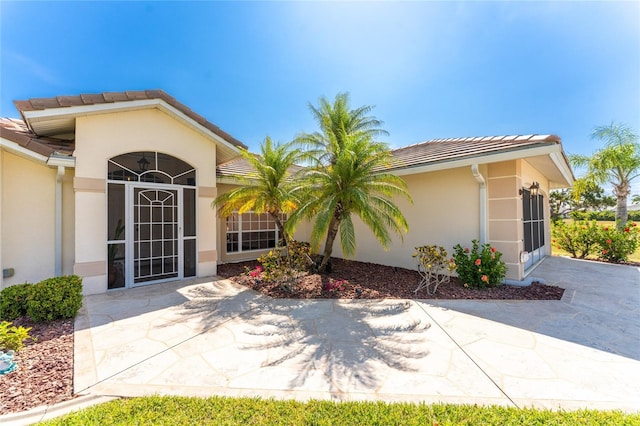 entrance to property with a patio