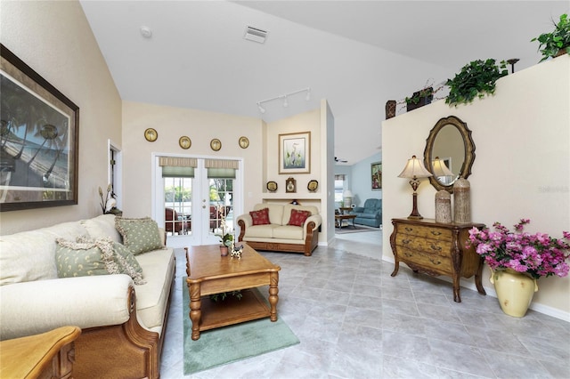 living room featuring vaulted ceiling and rail lighting