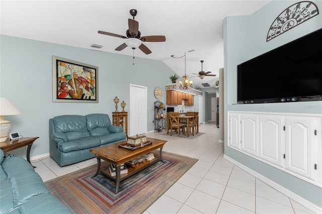 living room featuring ceiling fan, lofted ceiling, and light tile patterned floors