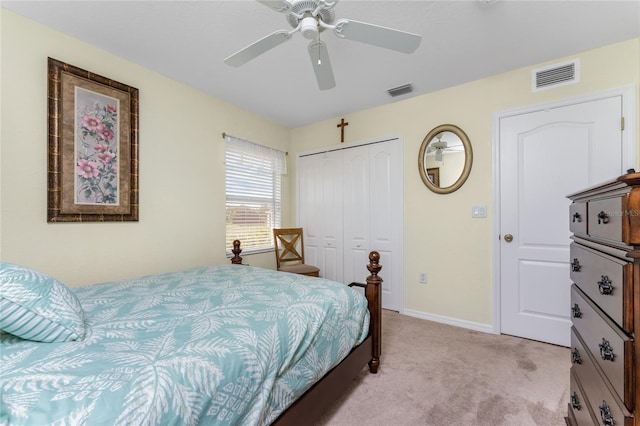 carpeted bedroom with ceiling fan and a closet