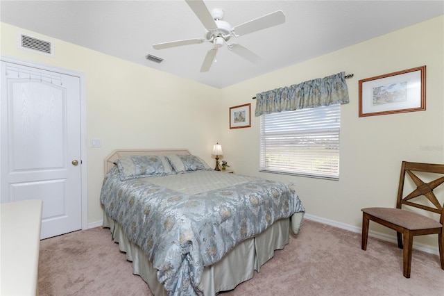 bedroom featuring light colored carpet and ceiling fan