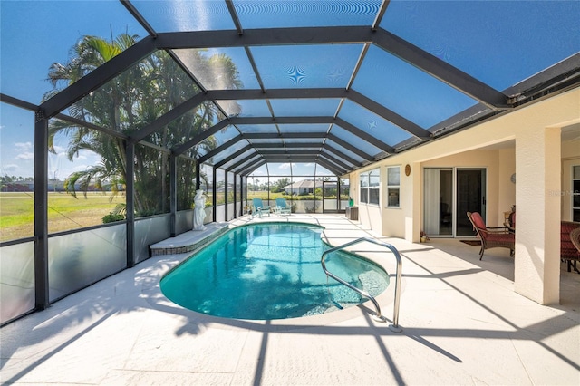 view of swimming pool featuring glass enclosure and a patio area