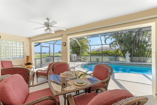 sunroom featuring ceiling fan