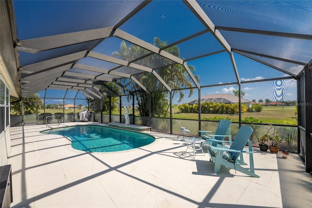 view of swimming pool with a patio and a lanai