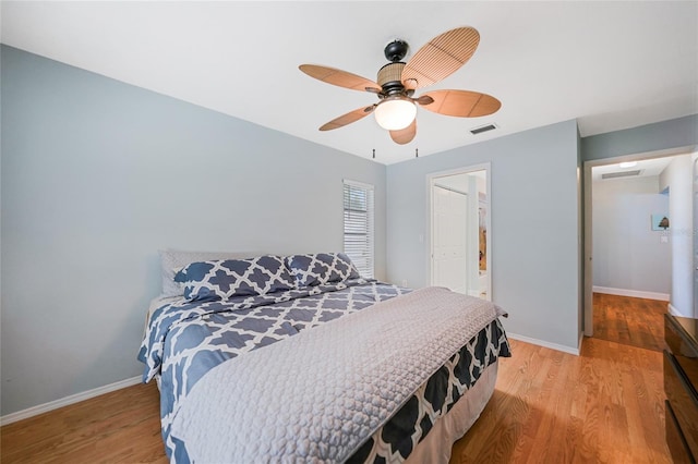 bedroom featuring ceiling fan, a closet, and light hardwood / wood-style floors