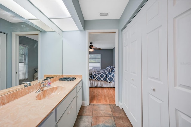 bathroom featuring vanity, hardwood / wood-style flooring, toilet, and ceiling fan