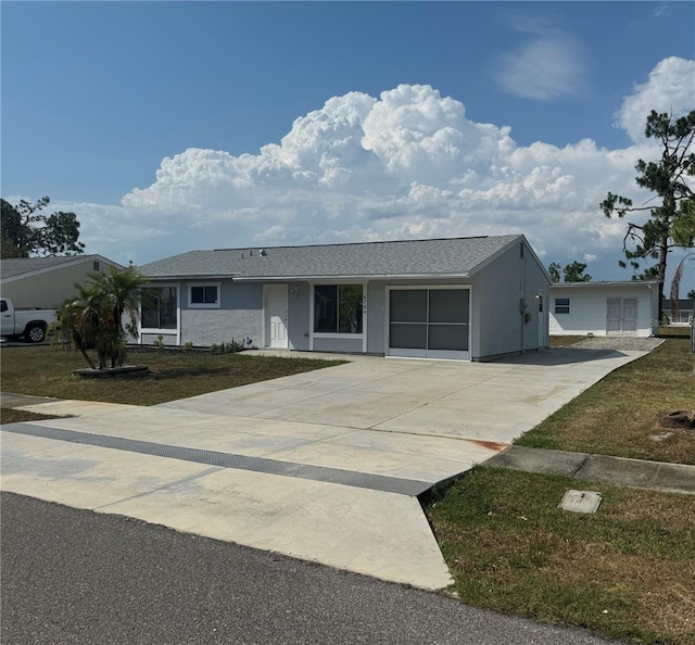 single story home featuring a garage and a front lawn