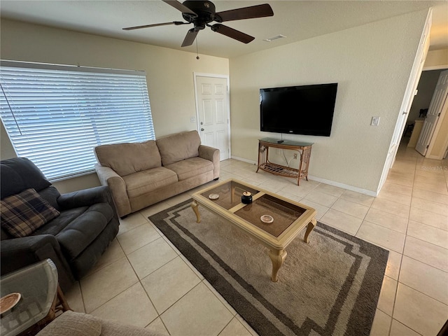 tiled living area with ceiling fan, visible vents, and baseboards