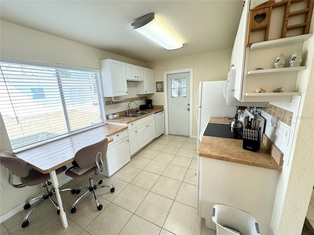 kitchen with decorative backsplash, white cabinets, open shelves, a sink, and light tile patterned flooring