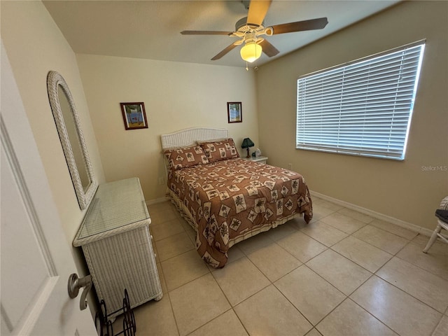 bedroom featuring a ceiling fan, light tile patterned flooring, and baseboards