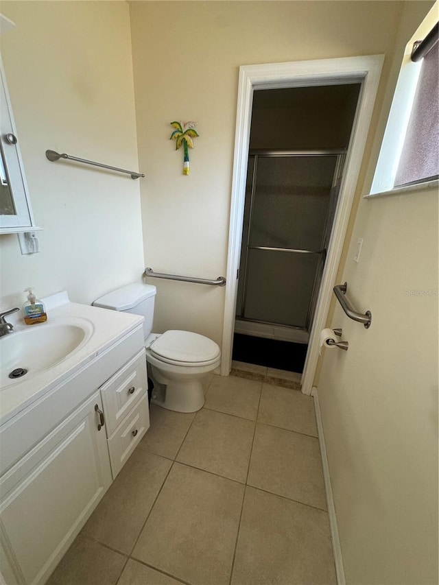 full bathroom featuring tile patterned flooring, toilet, a shower stall, and vanity