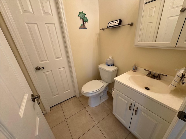 bathroom with toilet, tile patterned flooring, and vanity