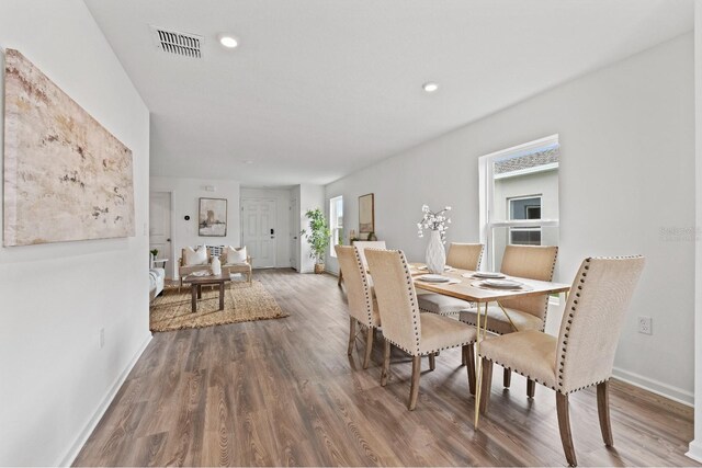 dining space with dark wood-type flooring