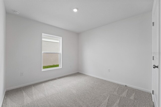 unfurnished room with carpet flooring