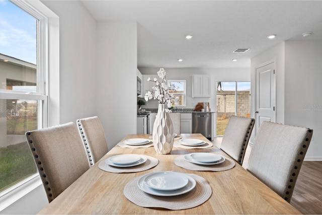 dining space with hardwood / wood-style flooring