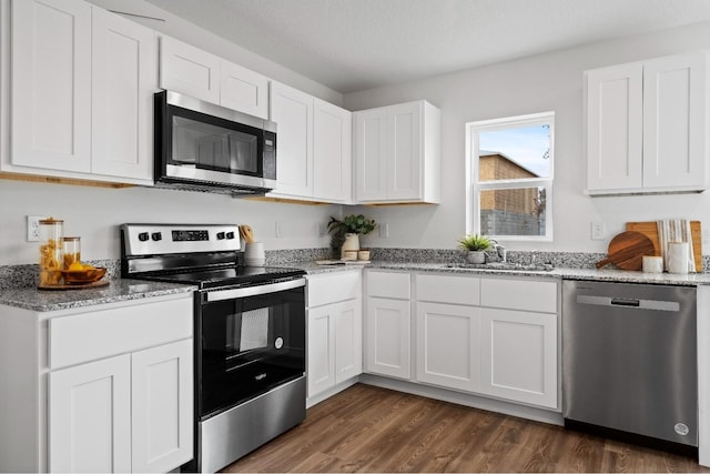 kitchen with white cabinets, appliances with stainless steel finishes, and sink