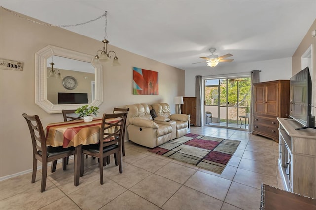 living room featuring light tile patterned floors and ceiling fan with notable chandelier